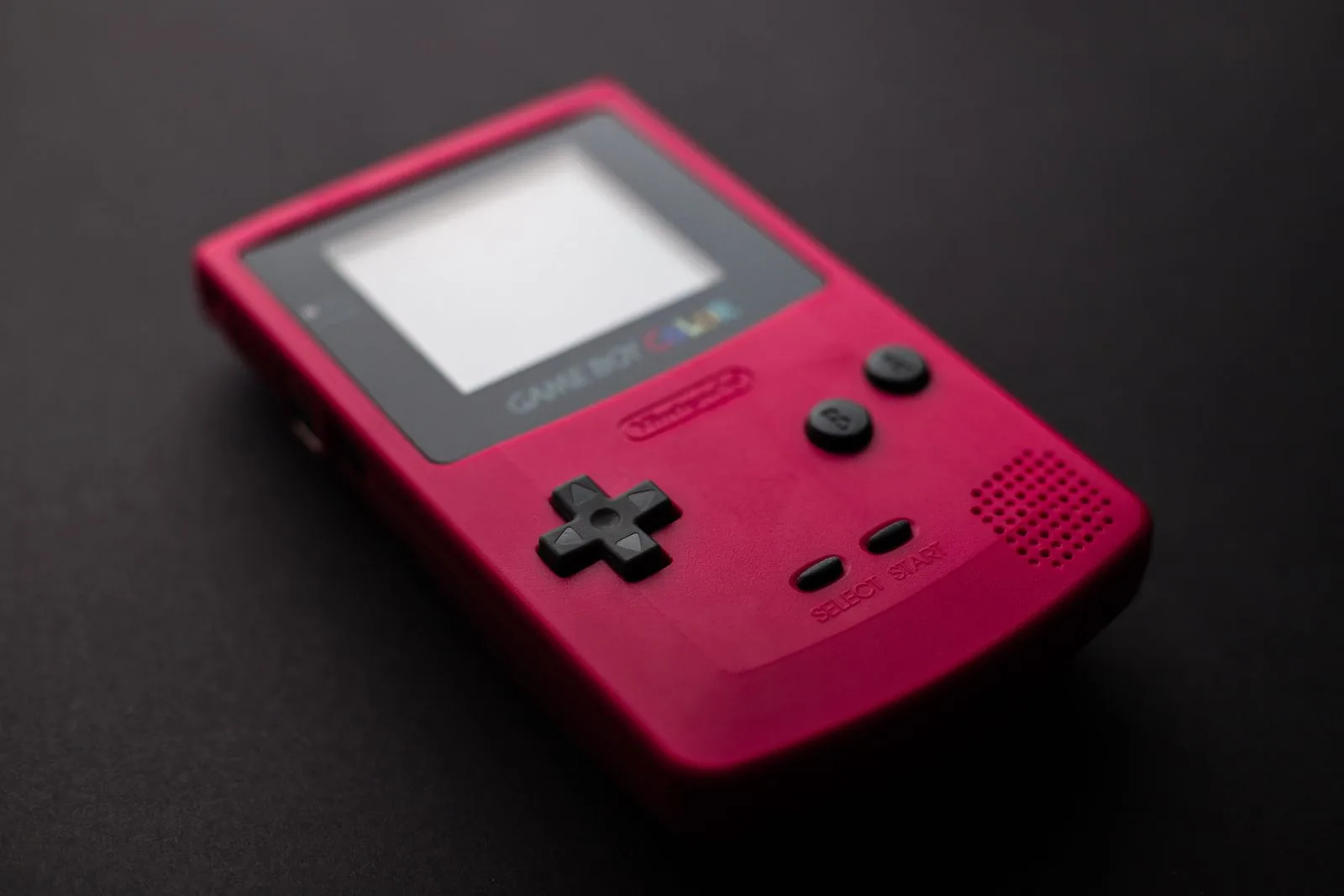 Close-up of a red Nintendo Game Boy handheld, the console behind the best Game Boy games
